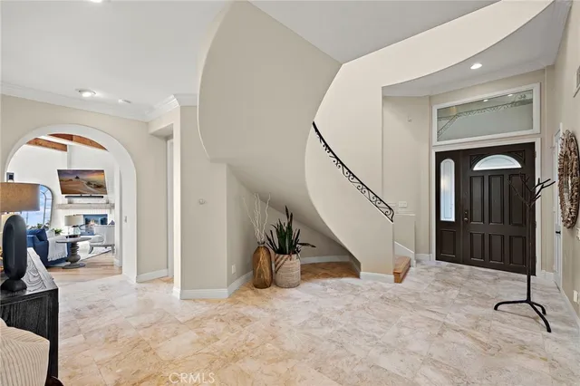 a large white kitchen with a stove a sink dishwasher and a refrigerator with wooden floor