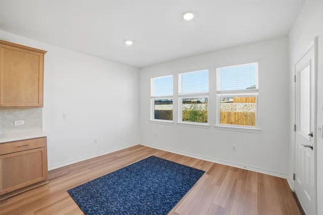 a kitchen with kitchen island a counter space a sink appliances and cabinets