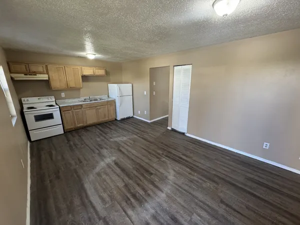 a kitchen with a refrigerator and a stove top oven