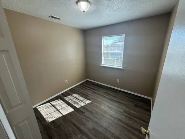 a view of wooden floor and windows in a room