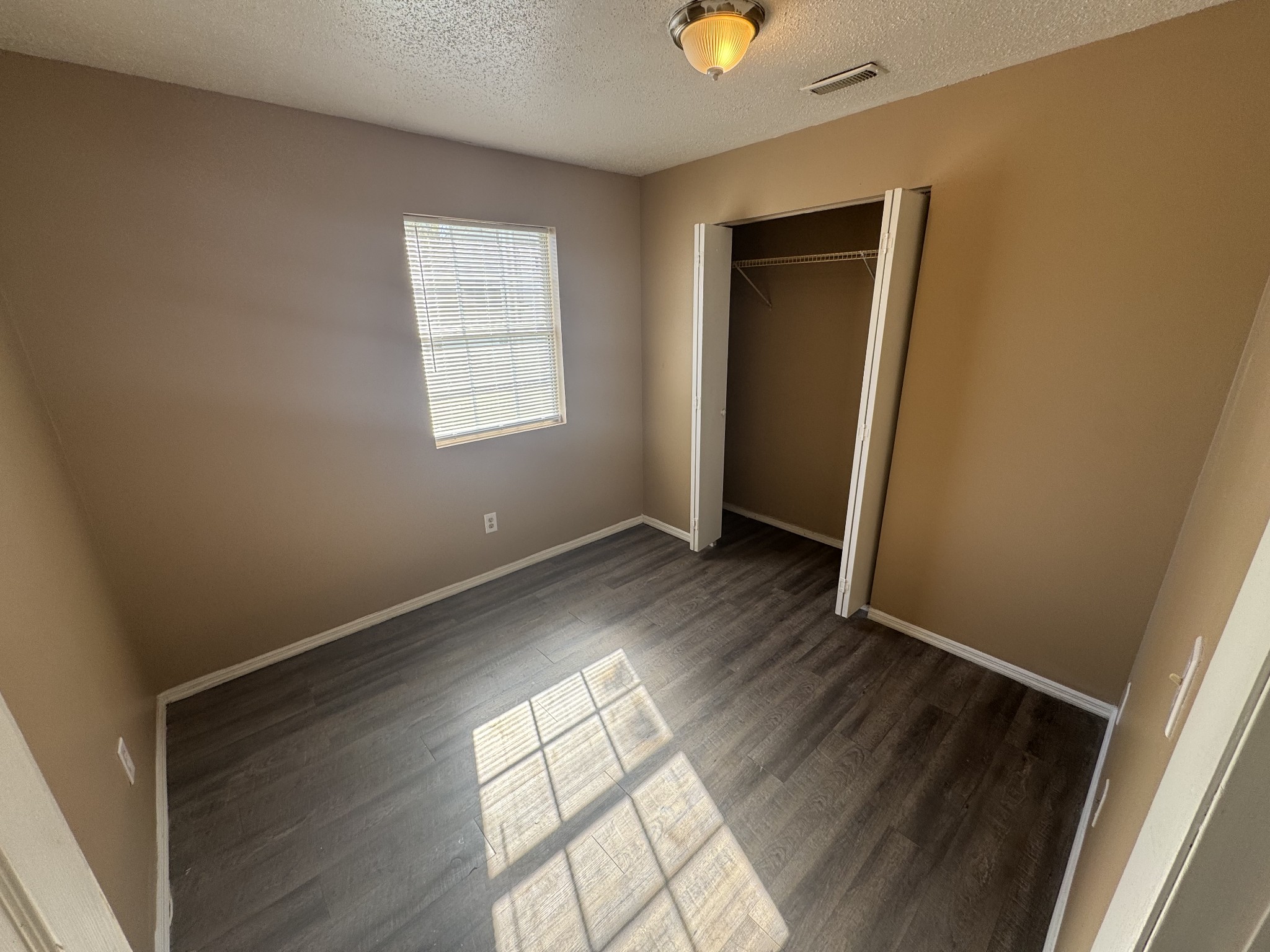 1523 Yager Road, Unit C3 McMinnville, TN 37110 - Photo 5 of 6 an empty room with wooden floor and windows