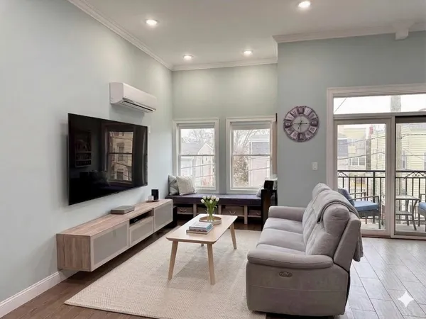 a living room with furniture and a flat screen tv