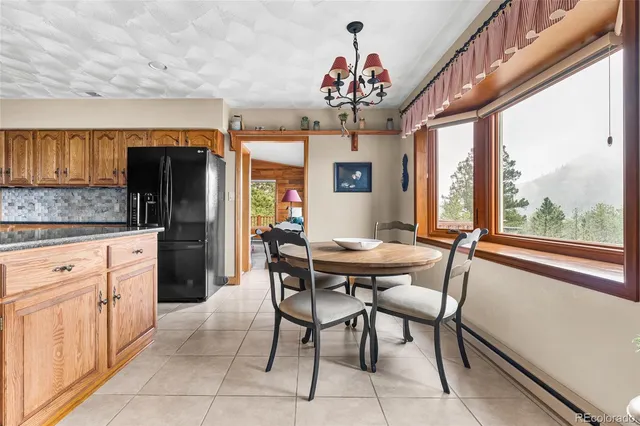 a kitchen with granite countertop a sink a stove and cabinets
