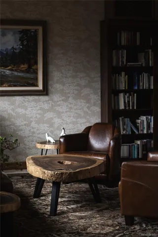 a living room with furniture and a bookshelf