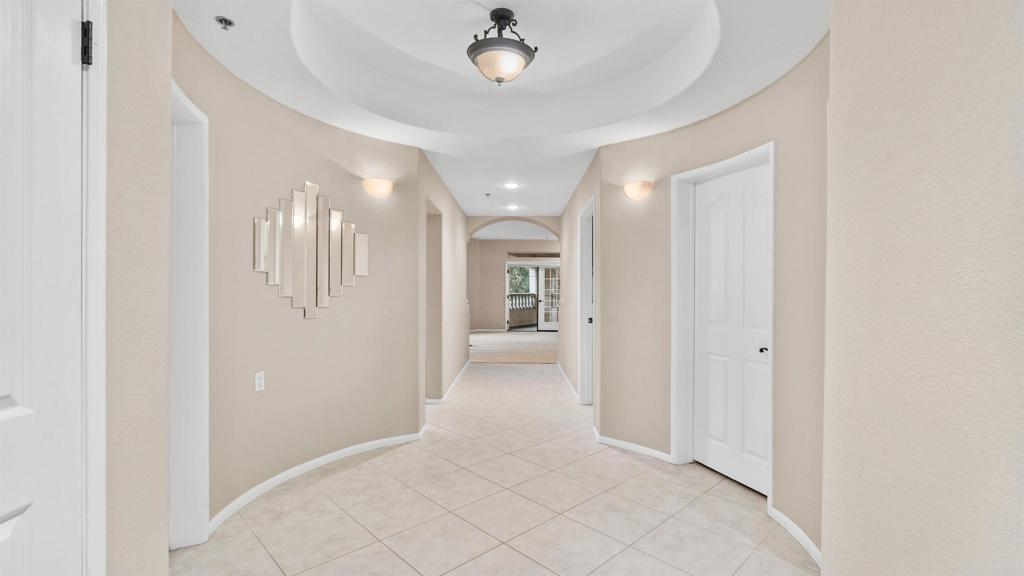 a view of a hallway with chandelier and entryway