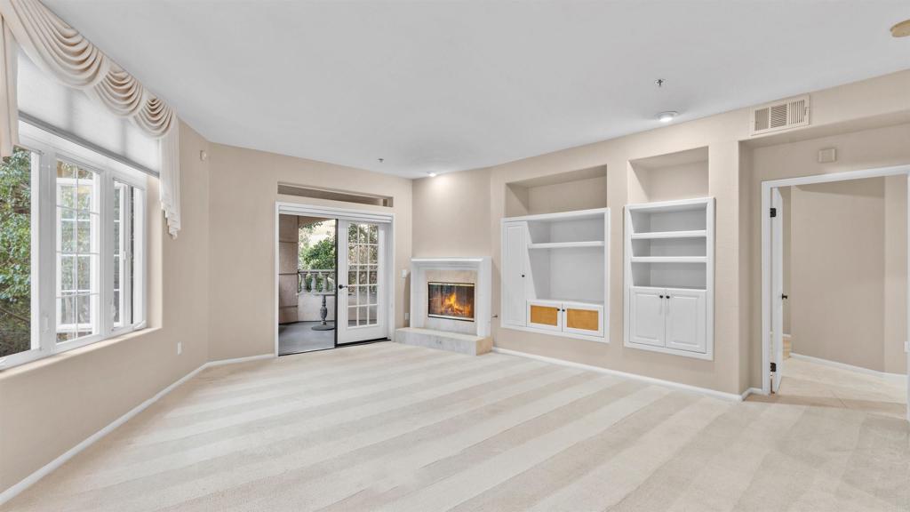 2894 Torrey Pines Road La Jolla, CA 92037 - Photo 10 of 46 a view of an empty room with a fireplace and a window