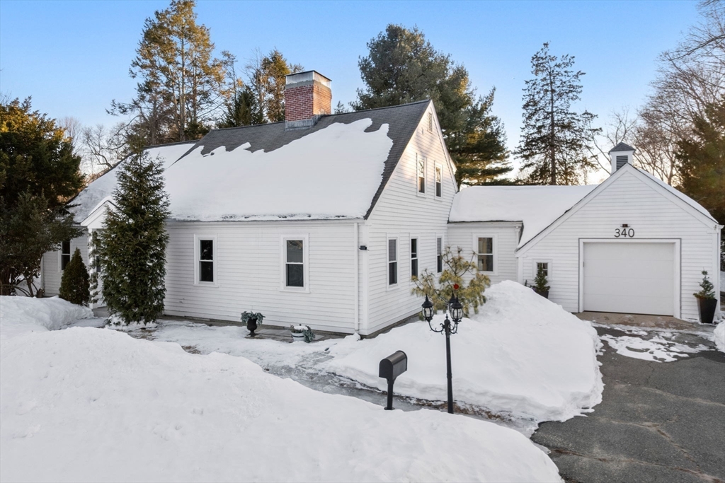 a view of a white house with a yard and garage
