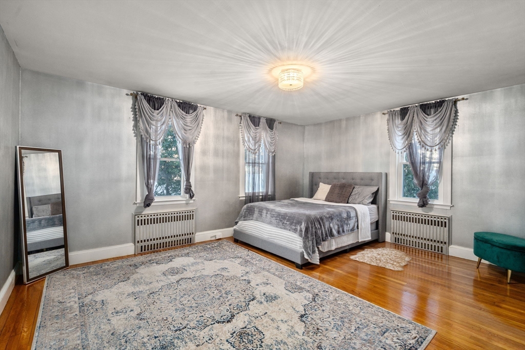 340 North Main Street Natick, MA 01760 - Photo 11 of 35 a spacious bedroom with a bed and a wooden floor