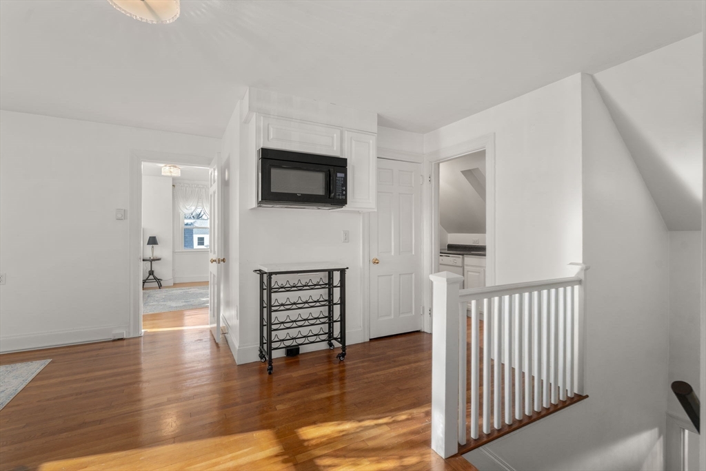 340 North Main Street Natick, MA 01760 - Photo 15 of 35 a view of a livingroom with wooden floor and a flat screen tv