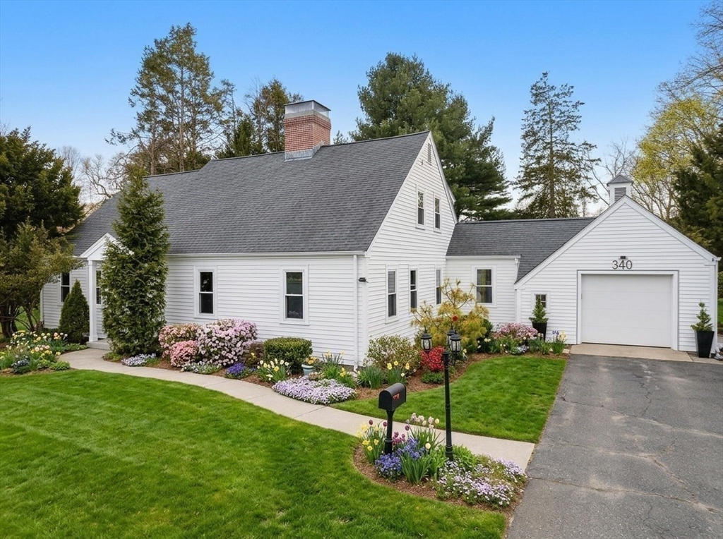 340 North Main Street Natick, MA 01760 - Photo 2 of 35 a view of a white house with a yard and garden