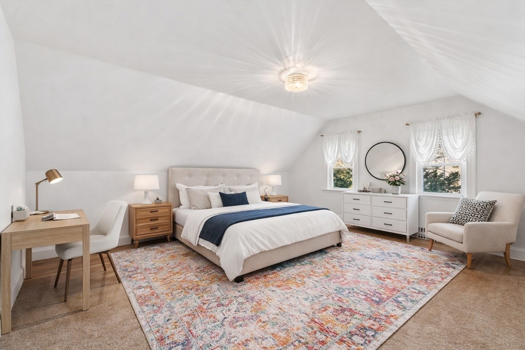 340 North Main Street Natick, MA 01760 - Photo 21 of 35 a bedroom with bed and a chandelier