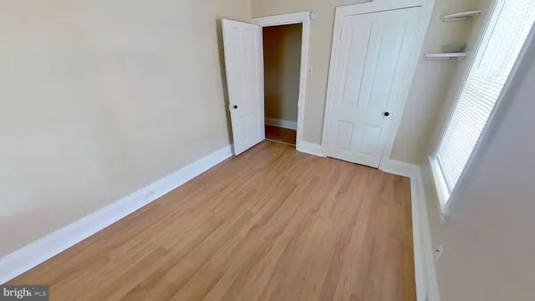 a view of hallway with wooden floor