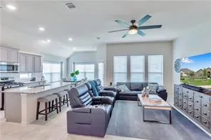 a living room with furniture and a large window