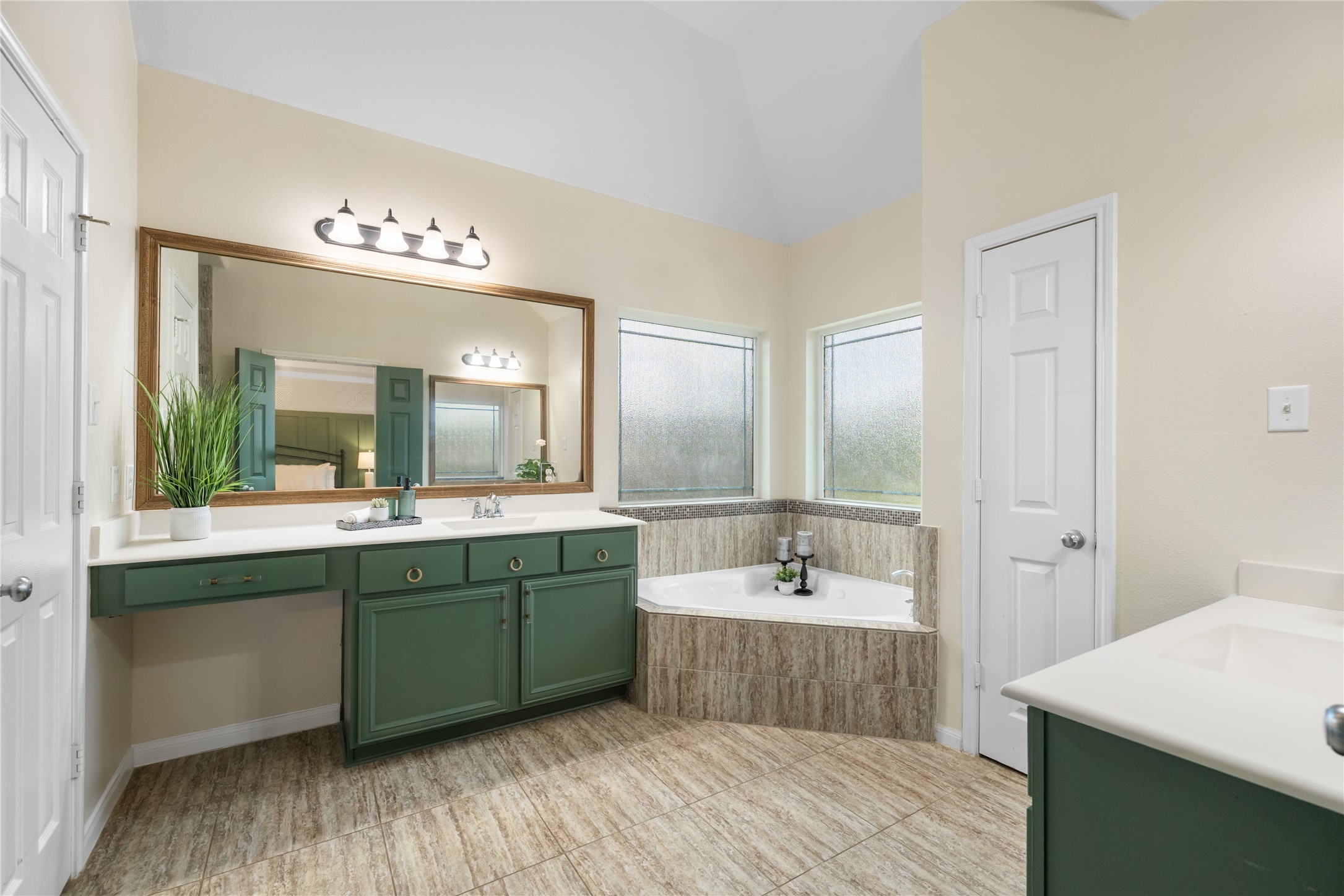 4502 Sunrise Road Baytown, TX 77523 - Photo 19 of 42 a spacious bathroom with a tub a sink and mirror