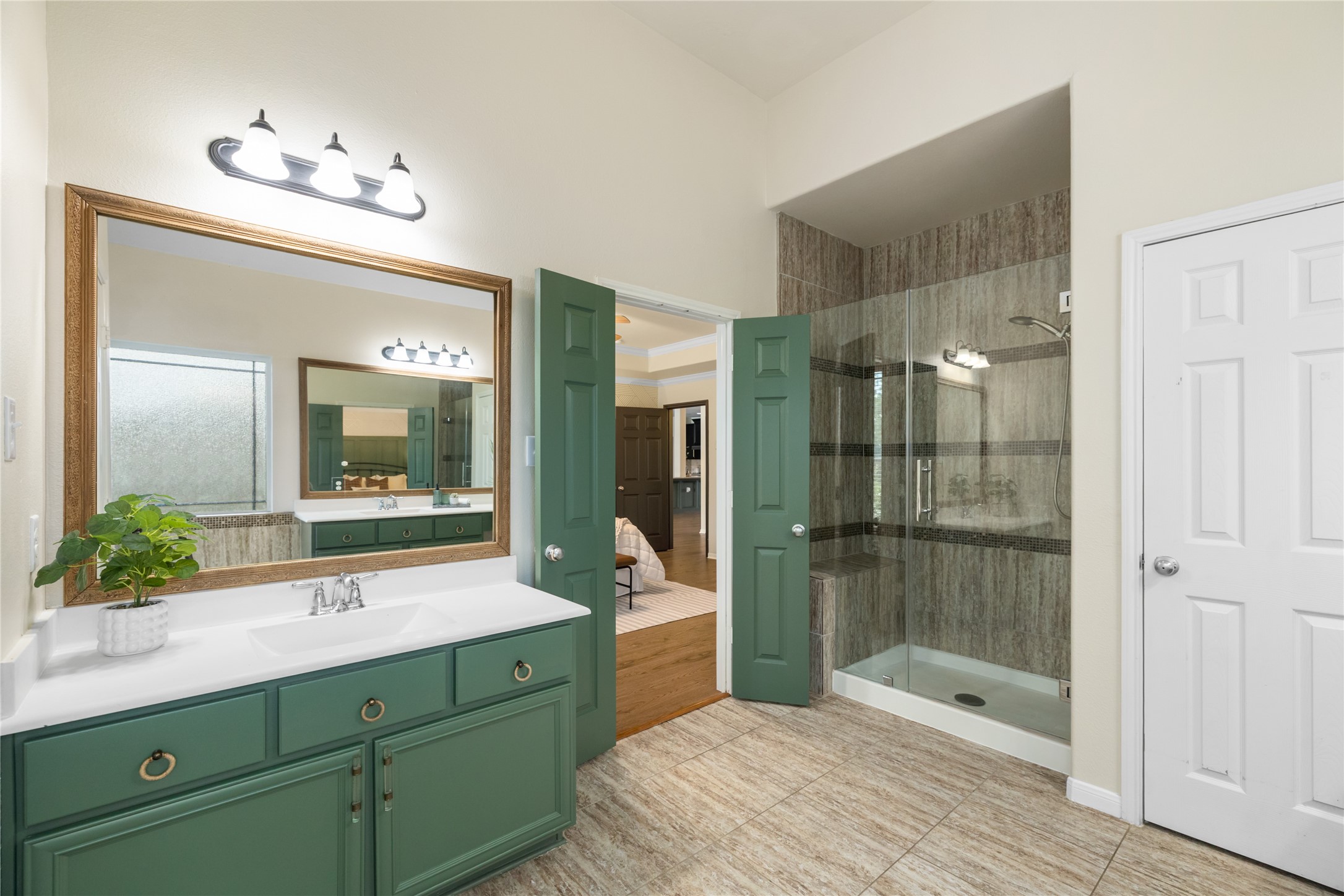 4502 Sunrise Road Baytown, TX 77523 - Photo 20 of 42 a spacious bathroom with a shower sink and mirror