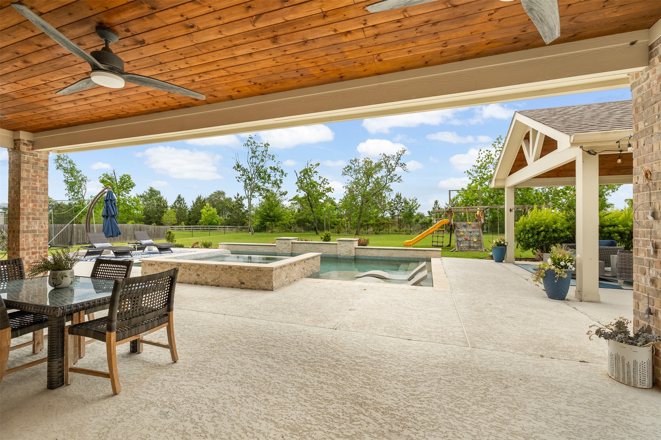4502 Sunrise Road Baytown, TX 77523 - Photo 31 of 42 a view of swimming pool with seating area and trees in the background