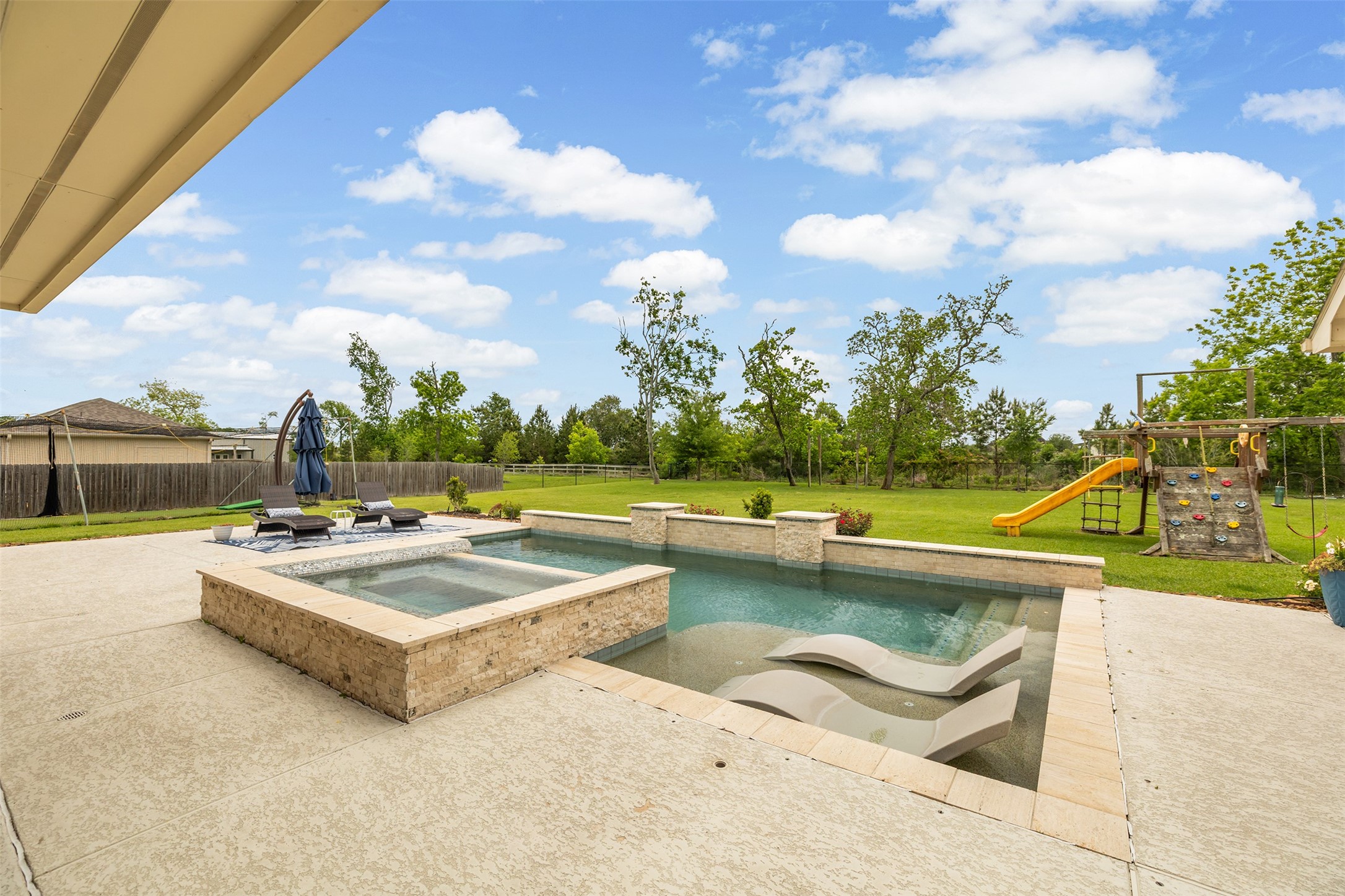4502 Sunrise Road Baytown, TX 77523 - Photo 32 of 42 a view of a swimming pool with seating area and furniture