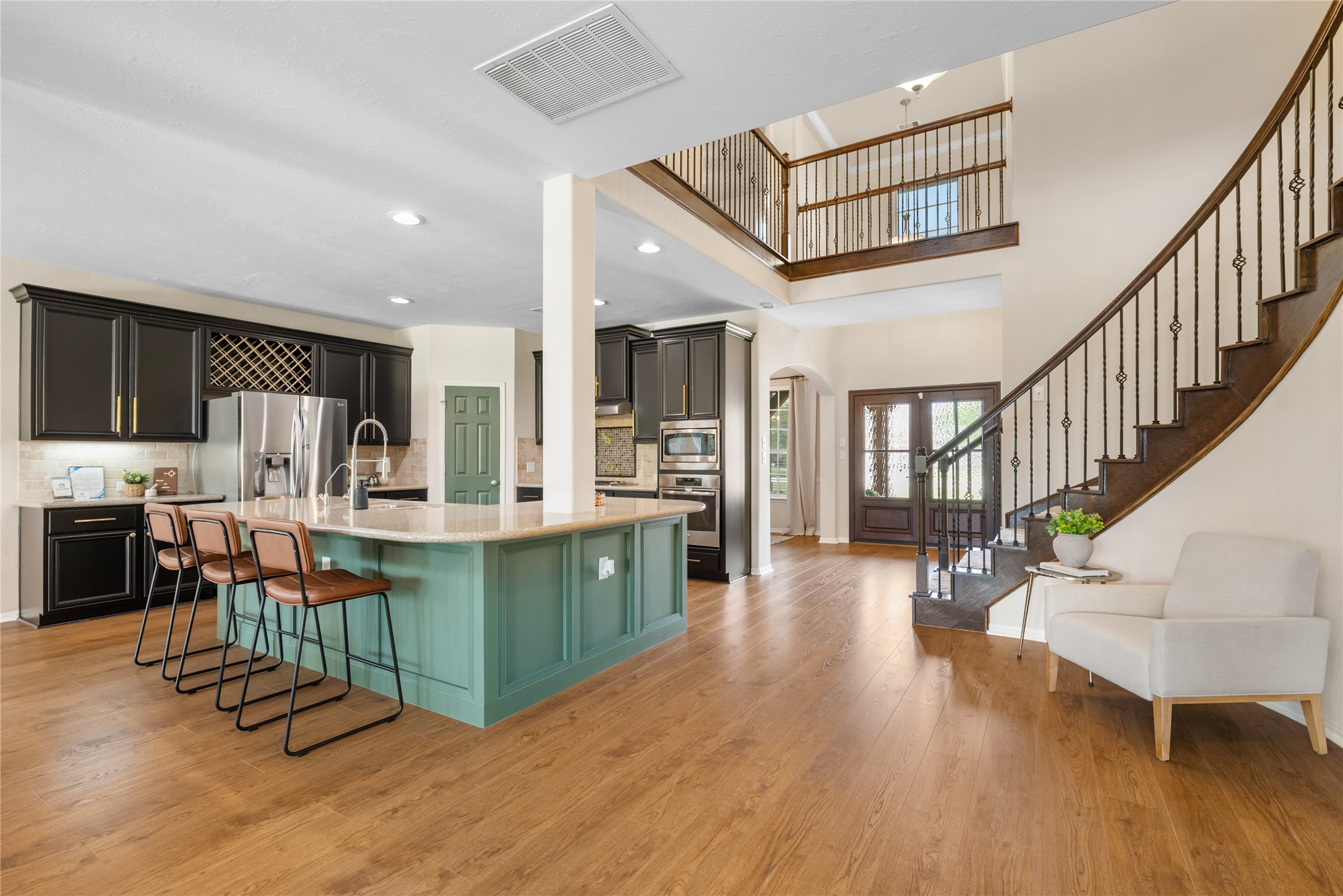 4502 Sunrise Road Baytown, TX 77523 - Photo 8 of 42 a kitchen with stainless steel appliances kitchen island granite countertop a table chairs in it and a wooden floors