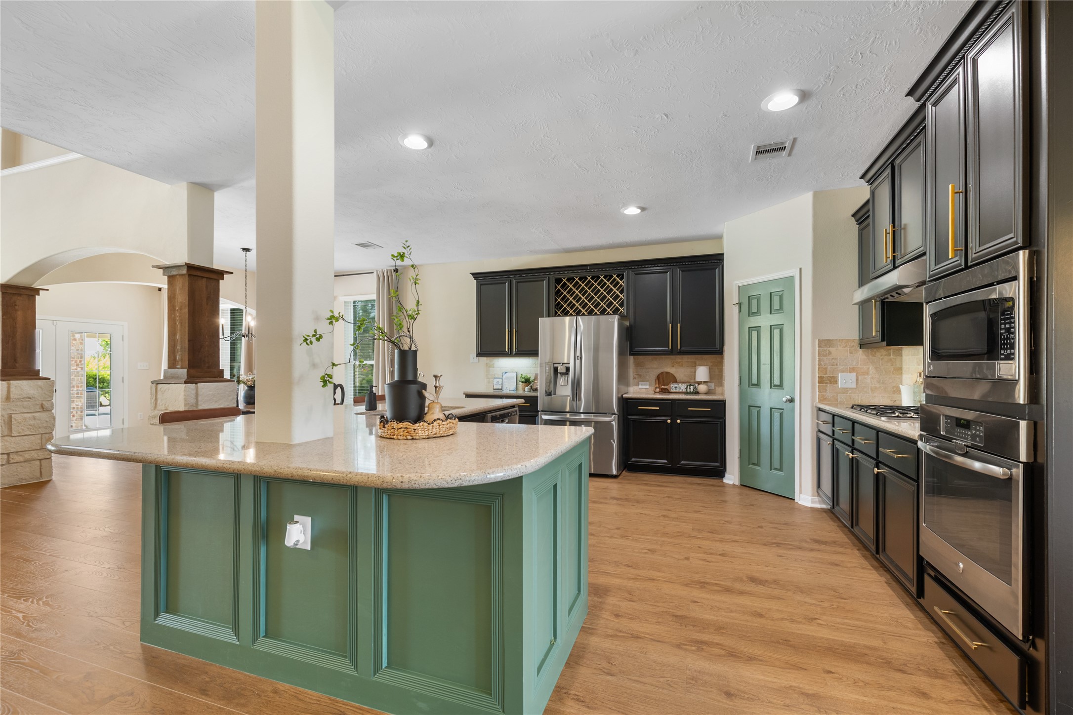 4502 Sunrise Road Baytown, TX 77523 - Photo 9 of 42 a kitchen with stainless steel appliances granite countertop a sink a stove and a refrigerator