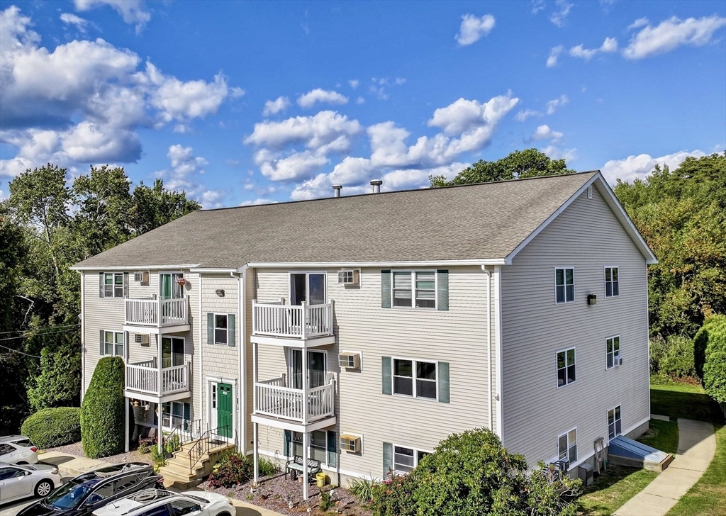 1619 Braley Road, Unit 98 New Bedford, MA 02745 - Photo 1 of 32 a view of a white house with a yard
