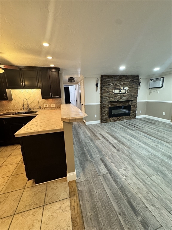 1619 Braley Road, Unit 98 New Bedford, MA 02745 - Photo 14 of 32 a living room with stainless steel appliances furniture a fireplace and a open kitchen view