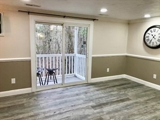 1619 Braley Road, Unit 98 New Bedford, MA 02745 - Photo 16 of 32 a view of a hallway with wooden floor