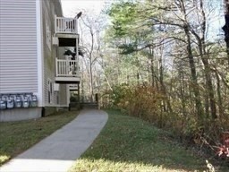 1619 Braley Road, Unit 98 New Bedford, MA 02745 - Photo 4 of 32 a backyard of a house with table and chairs