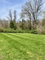 1619 Braley Road, Unit 98 New Bedford, MA 02745 - Photo 8 of 32 a view of a field with grass and trees