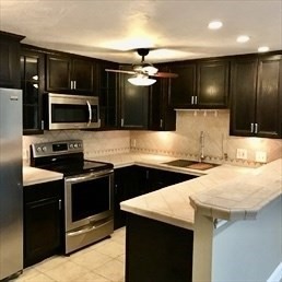 1619 Braley Road, Unit 98 New Bedford, MA 02745 - Photo 9 of 32 a kitchen with granite countertop a stove and a microwave