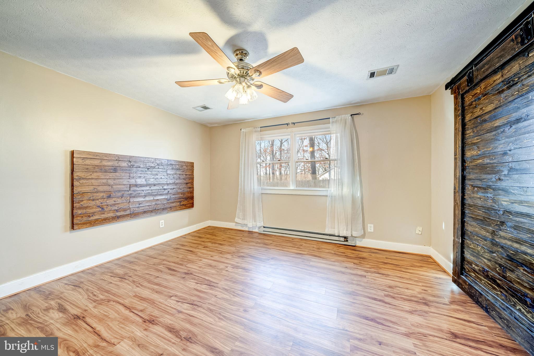 8487 Leeds Manor Road Warrenton, VA 20186 - Photo 30 of 53 Master bedroom with sliding barn door to walk-ins