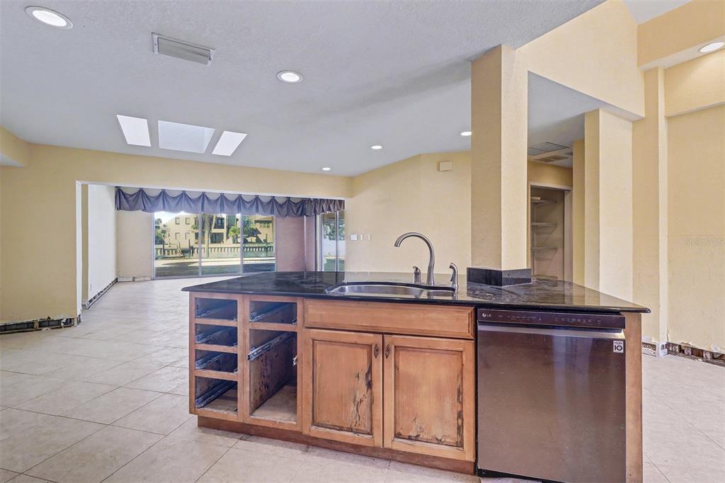 15918 Redington Drive Redington Beach, FL 33708 - Photo 11 of 33 a kitchen with stainless steel appliances granite countertop a sink and cabinets