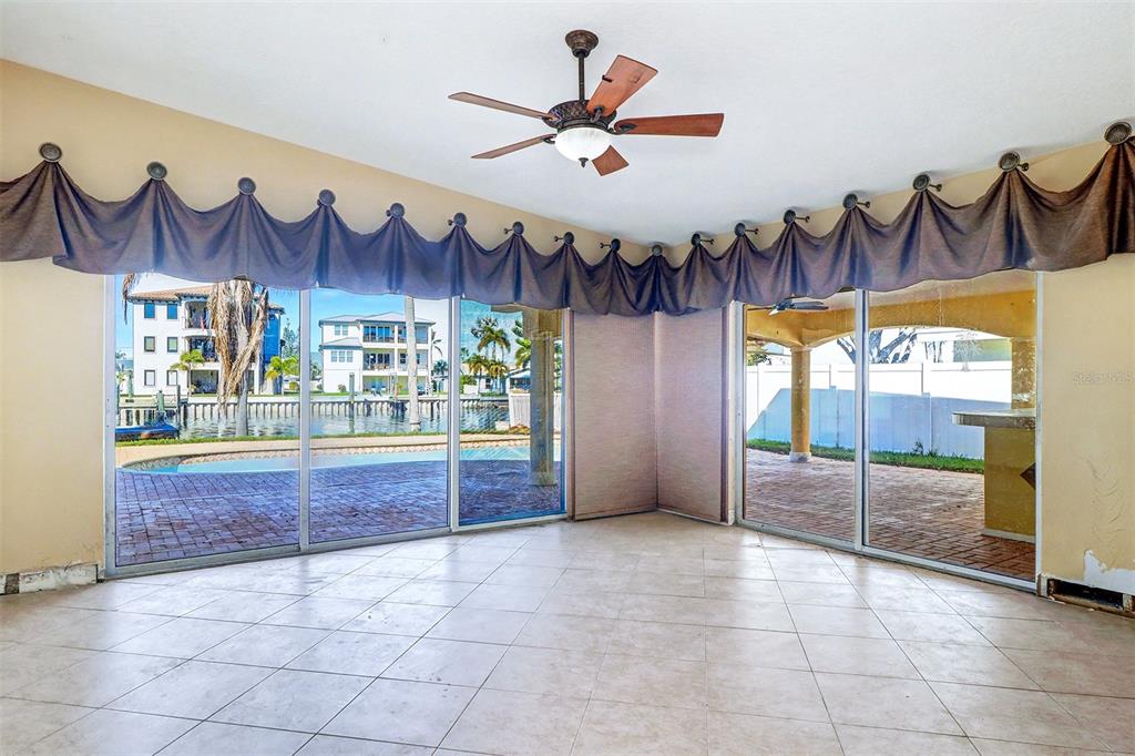 15918 Redington Drive Redington Beach, FL 33708 - Photo 14 of 33 a view of an entrance and a fireplace with a chandelier