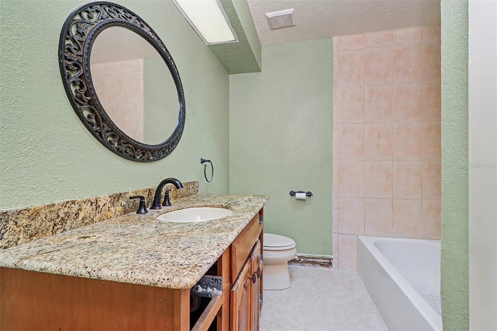 15918 Redington Drive Redington Beach, FL 33708 - Photo 20 of 33 a bathroom with a granite countertop sink and a mirror