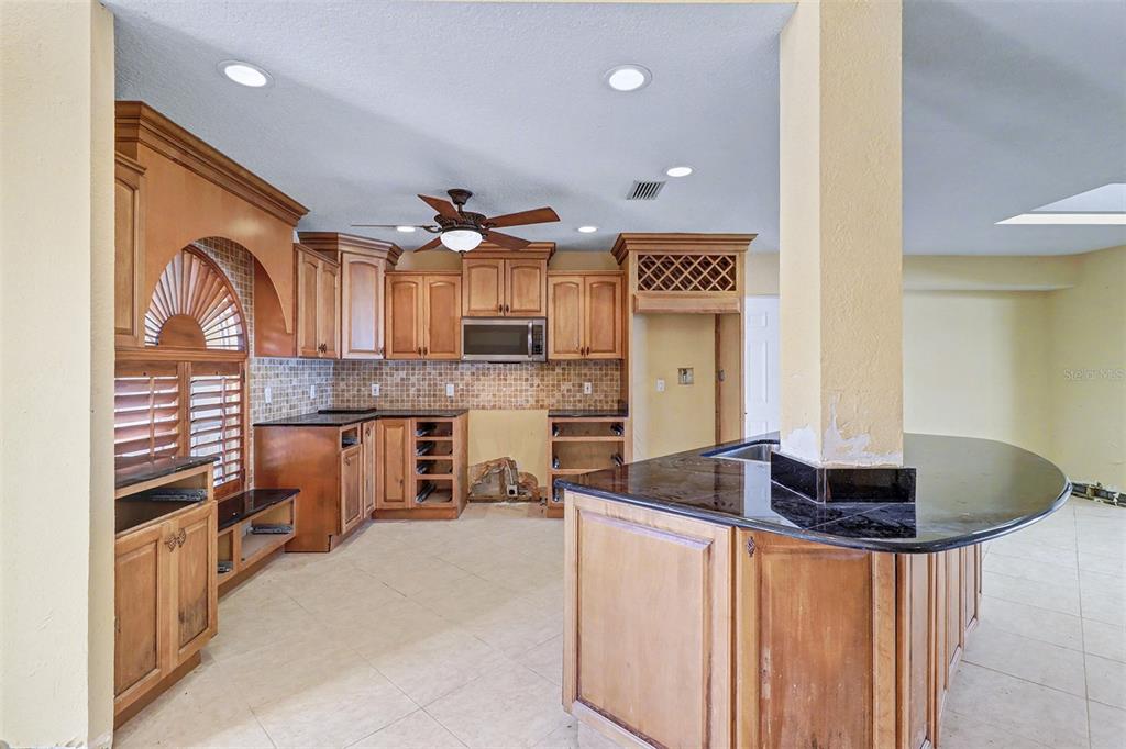 15918 Redington Drive Redington Beach, FL 33708 - Photo 8 of 33 a kitchen with stainless steel appliances granite countertop a sink and a refrigerator