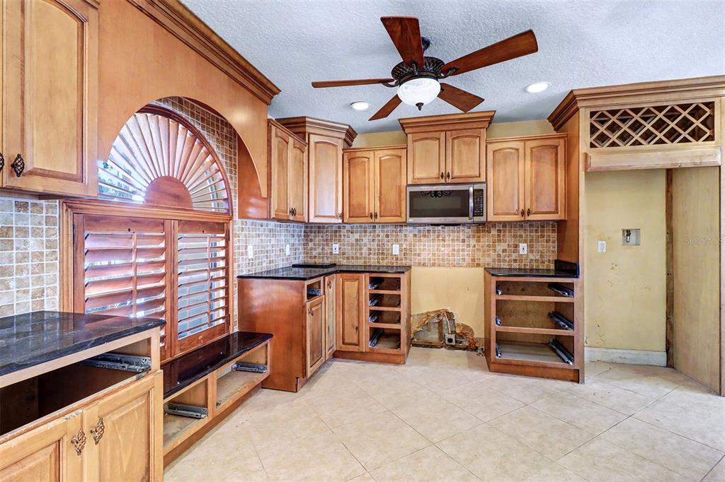 15918 Redington Drive Redington Beach, FL 33708 - Photo 9 of 33 a kitchen with a stove and a microwave