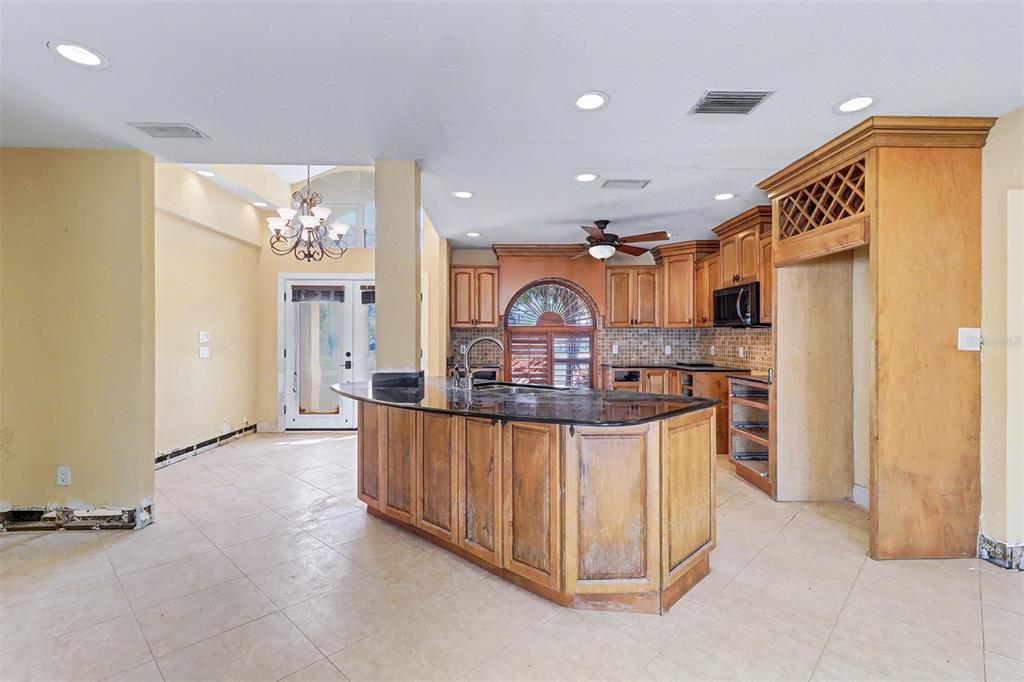 15918 Redington Drive Redington Beach, FL 33708 - Photo 10 of 33 a open kitchen with stainless steel appliances granite countertop a stove and a refrigerator