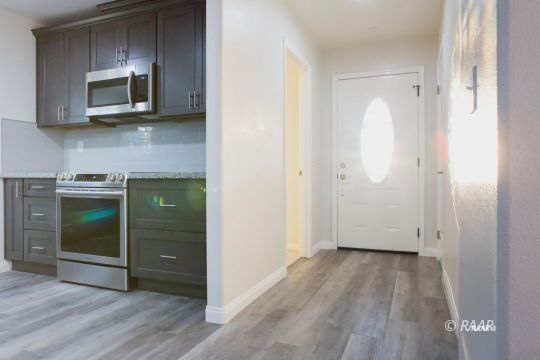 1308 Sims Street Ridgecrest, CA 93555 - Photo 3 of 12 a view of a kitchen with a sink and a microwave