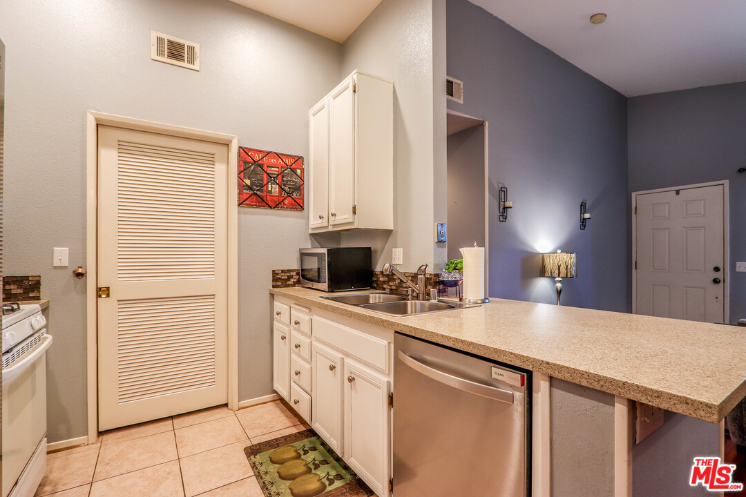 363 Chaumont Circle Foothill Ranch, CA 92610 - Photo 13 of 20 a kitchen with granite countertop a sink and cabinets