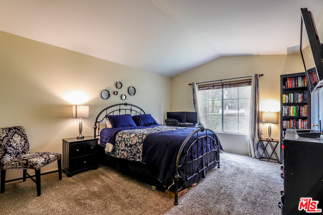 363 Chaumont Circle Foothill Ranch, CA 92610 - Photo 5 of 20 a bedroom with a bed a book shelf and a window