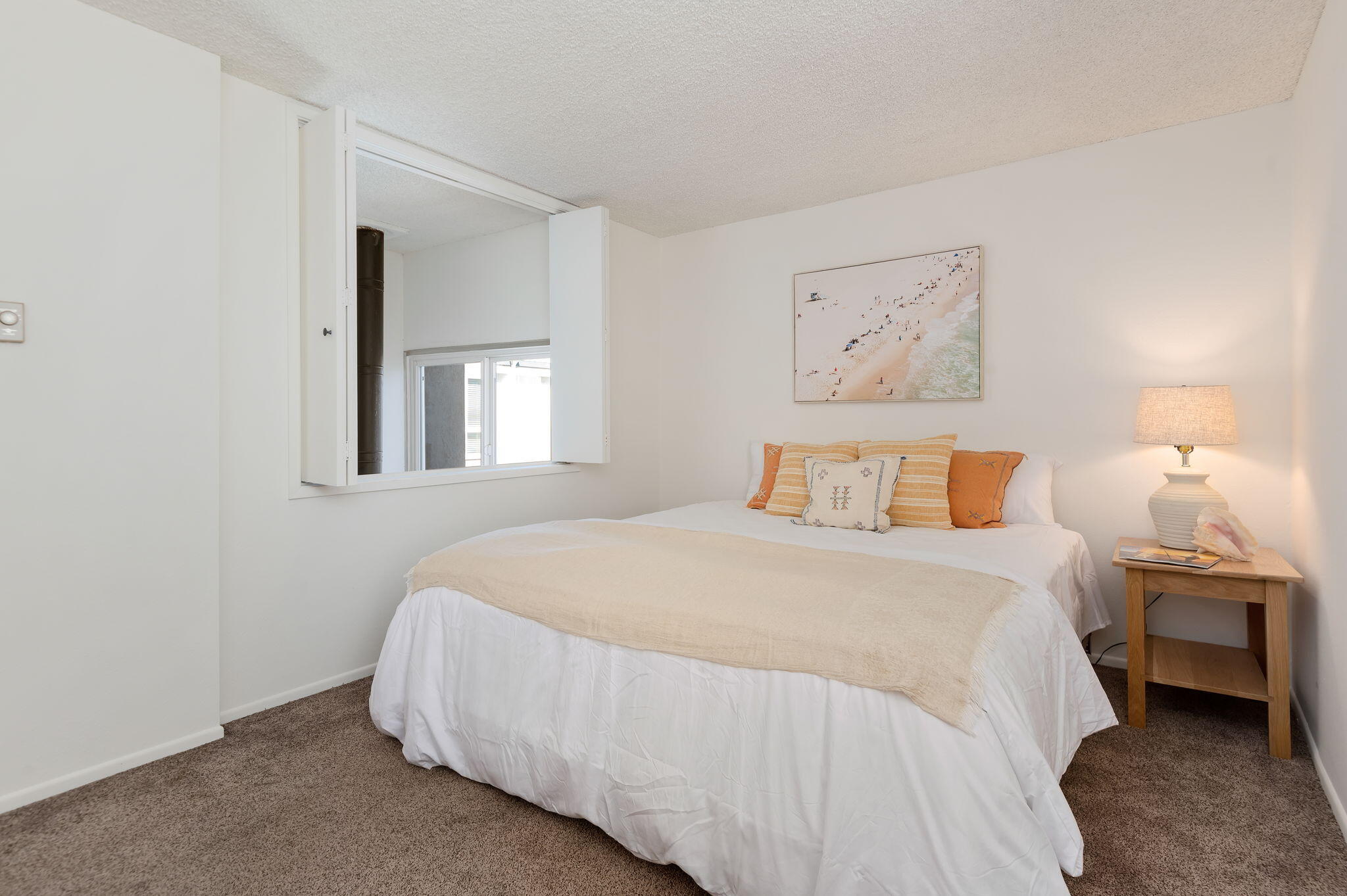 4700 Sandyland Road, Unit 35 Carpinteria, CA 93013 - Photo 14 of 38 a bedroom with a bed and painting on the wall