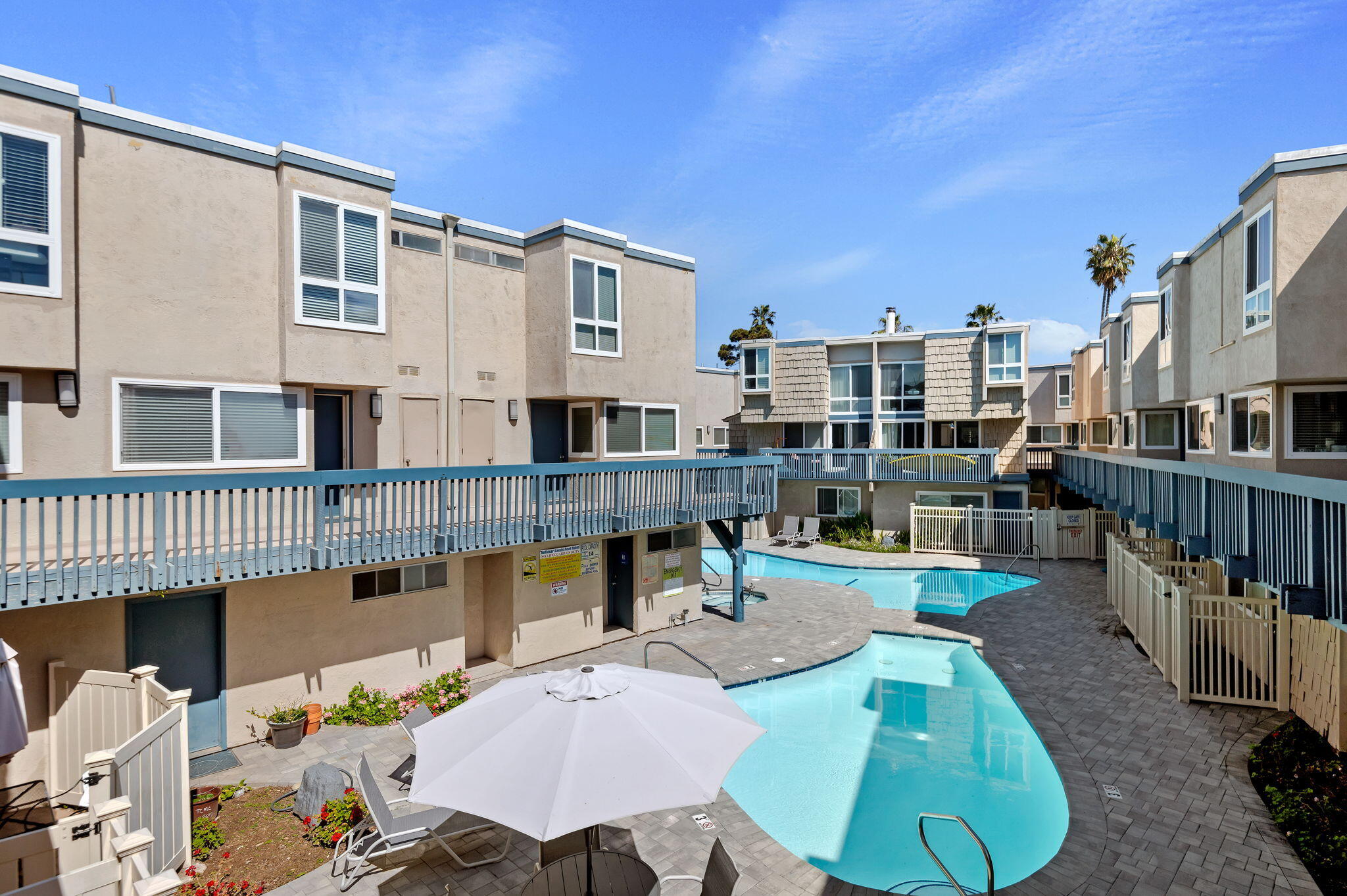 4700 Sandyland Road, Unit 35 Carpinteria, CA 93013 - Photo 10 of 38 a view of a patio with couches chairs dining table and chairs with wooden floor