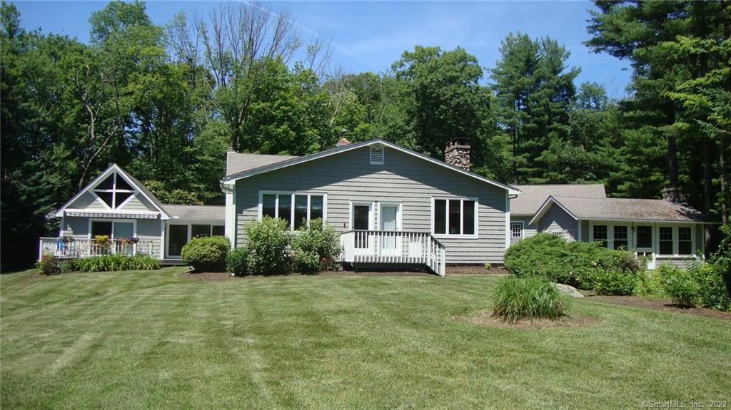 a front of a house with yard and green space