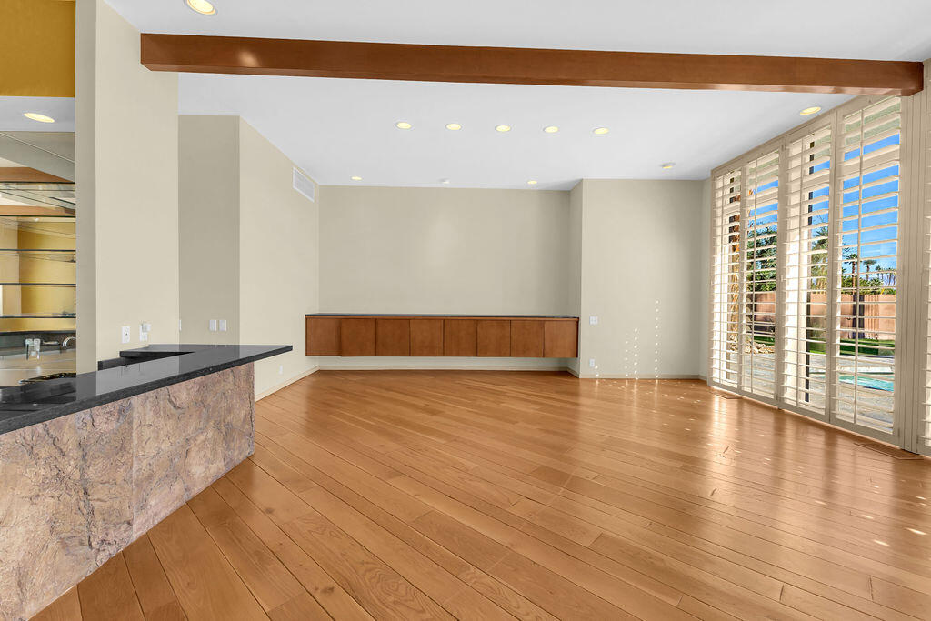 1421 Tamarisk W Street, Unit 3 Rancho Mirage, CA 92270 - Photo 12 of 65 a view of room with window and wooden floor