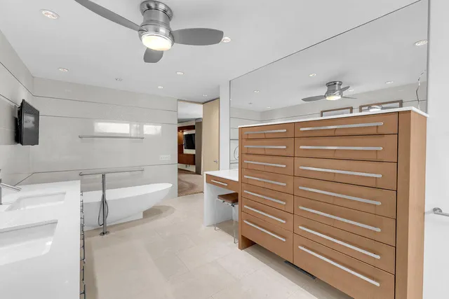 a view of a city with lots of residential buildings ocean and mountain view in back