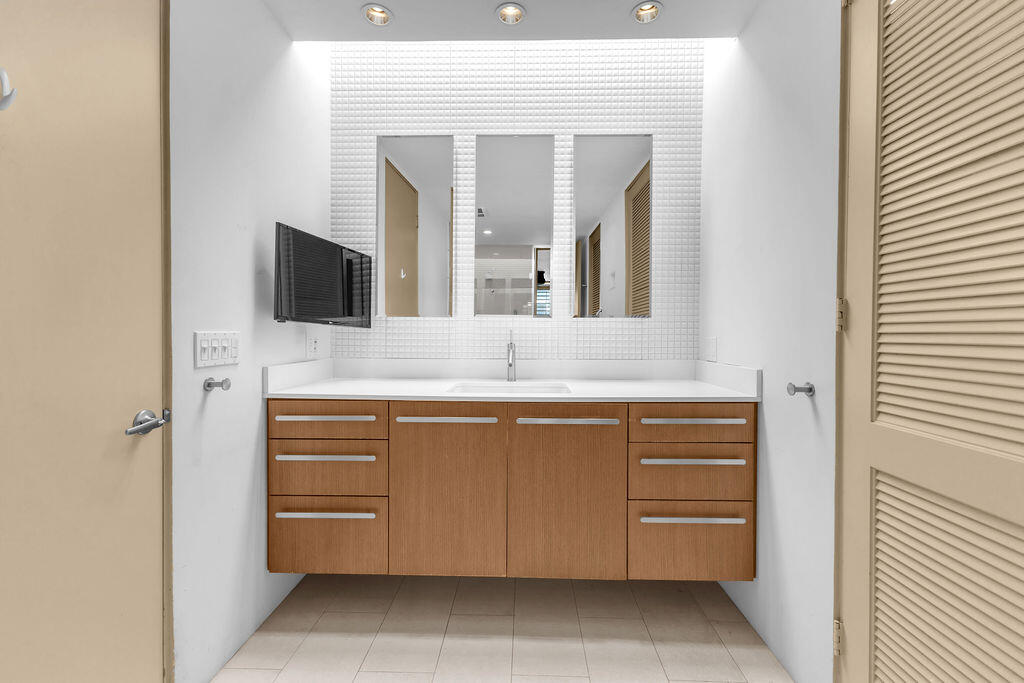 1421 Tamarisk W Street, Unit 3 Rancho Mirage, CA 92270 - Photo 29 of 65 a bathroom with a sink and a mirror