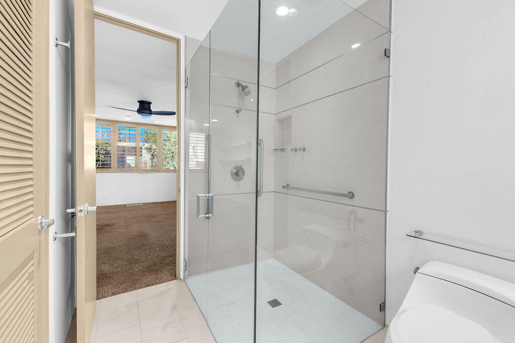 1421 Tamarisk W Street, Unit 3 Rancho Mirage, CA 92270 - Photo 30 of 65 a bathroom with a shower and a bath tub