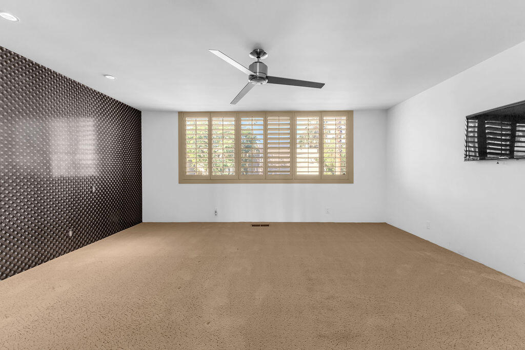 1421 Tamarisk W Street, Unit 3 Rancho Mirage, CA 92270 - Photo 33 of 65 a view of an empty room with a window