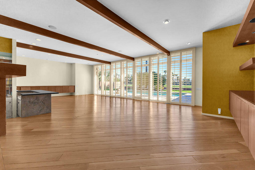 1421 Tamarisk W Street, Unit 3 Rancho Mirage, CA 92270 - Photo 6 of 65 a view of empty room with wooden floor and fan