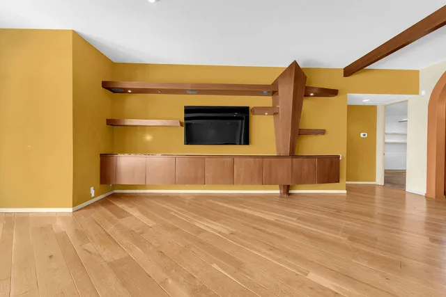 a view of hallway with stairs and wooden floor