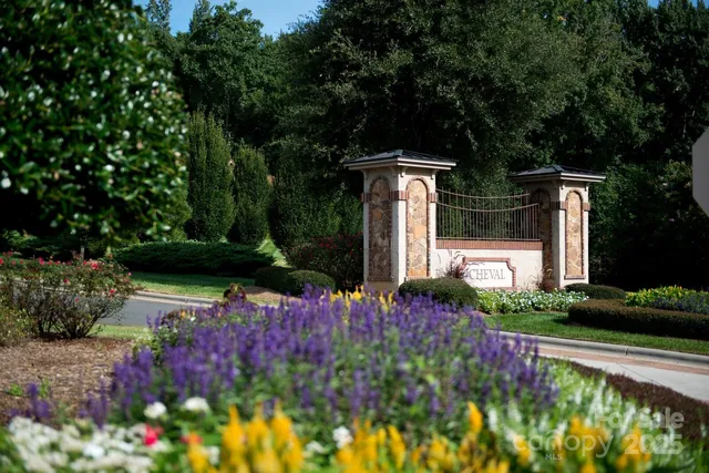 a view of flower garden with wooden fence